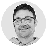 Anthony Andreoli black and white headshot inside circle