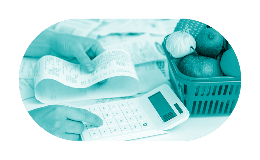 Hands using calculator to work out cost of food bills on receipt