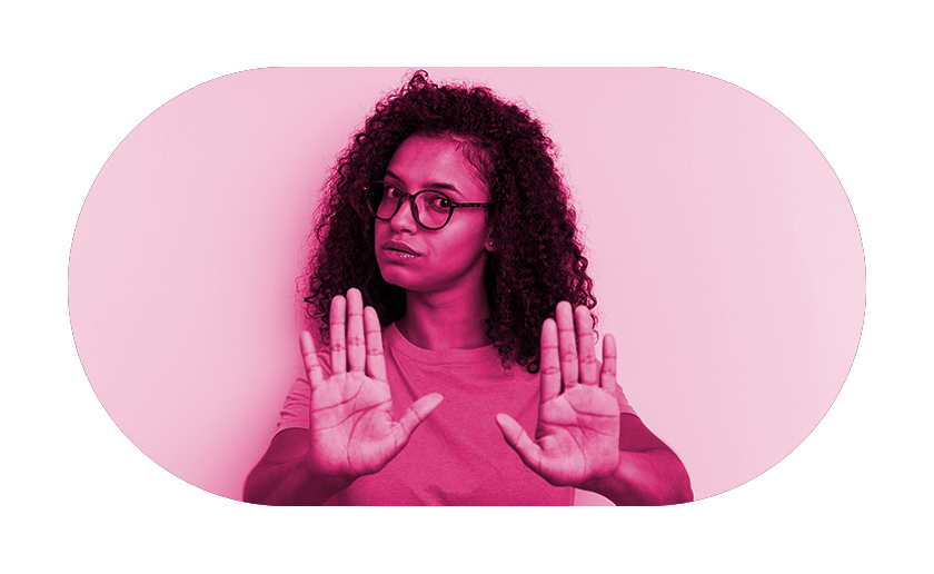 Woman holding out hands in front to say stop on pink overlay