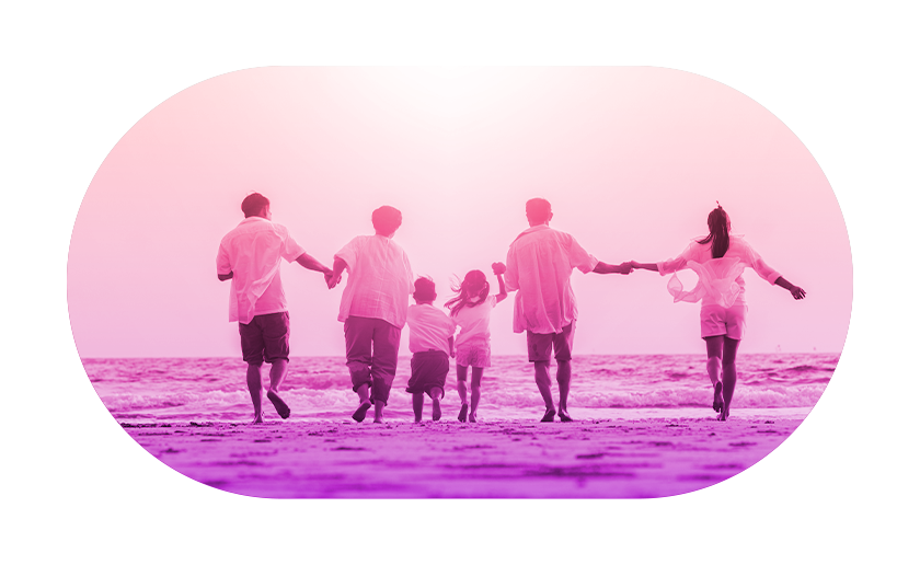 People joined hands walking towards the sea