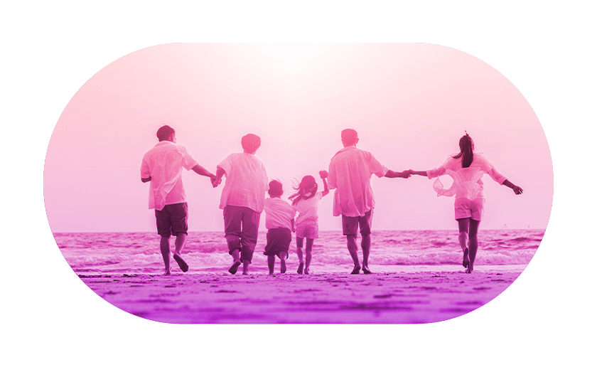 People joined hands walking towards the sea